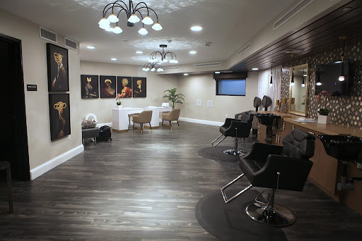 A modern hair salon featuring sleek furniture, artistic decor, and stylish lighting.