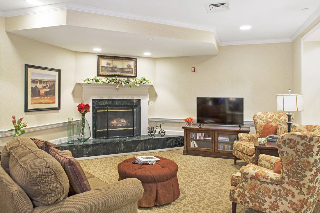 A cozy living room with a fireplace, television, and comfortable seating arrangement.