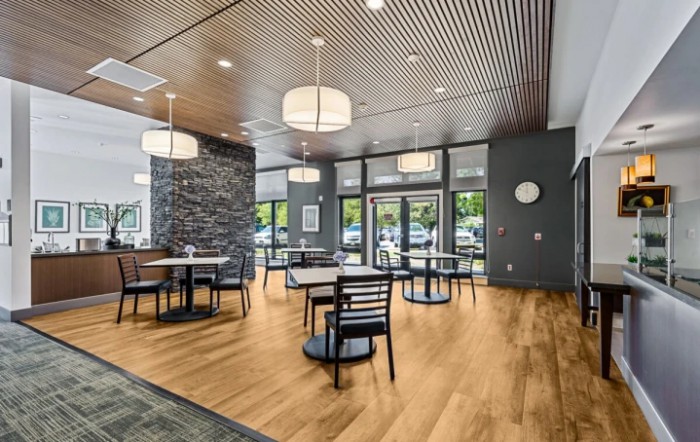 A modern dining area with sleek furniture and contemporary lighting.