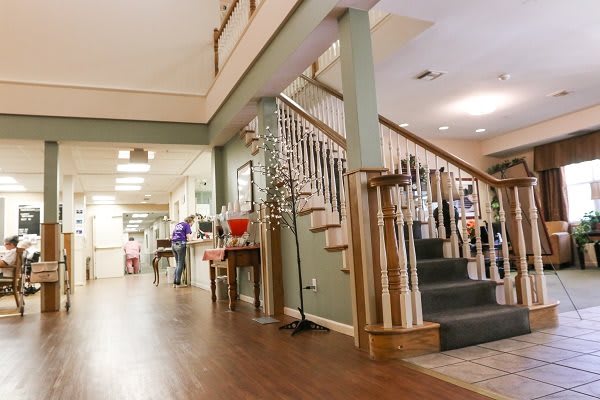 A cozy interior hallway featuring a wooden staircase and polished floors.