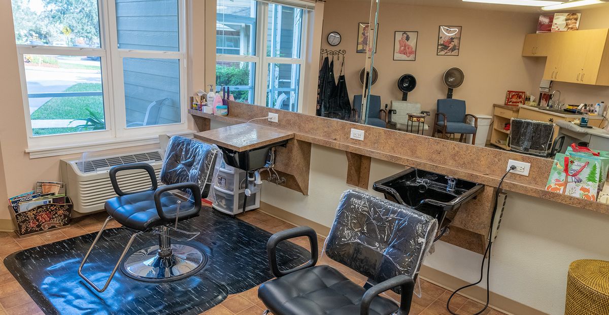 A neat and organized hair salon interior with styling chairs and mirrors.