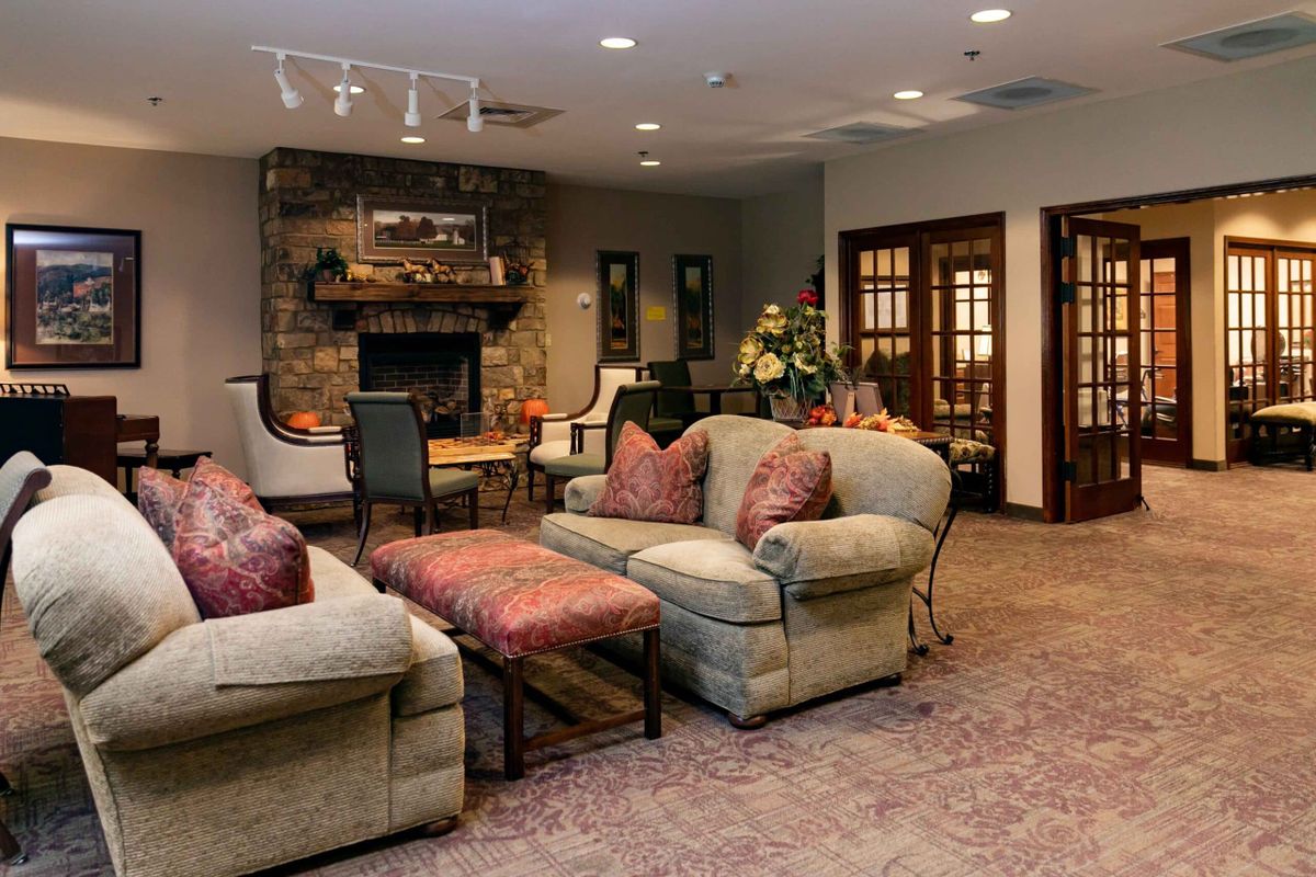 A cozy living room with comfortable sofas and a fireplace.