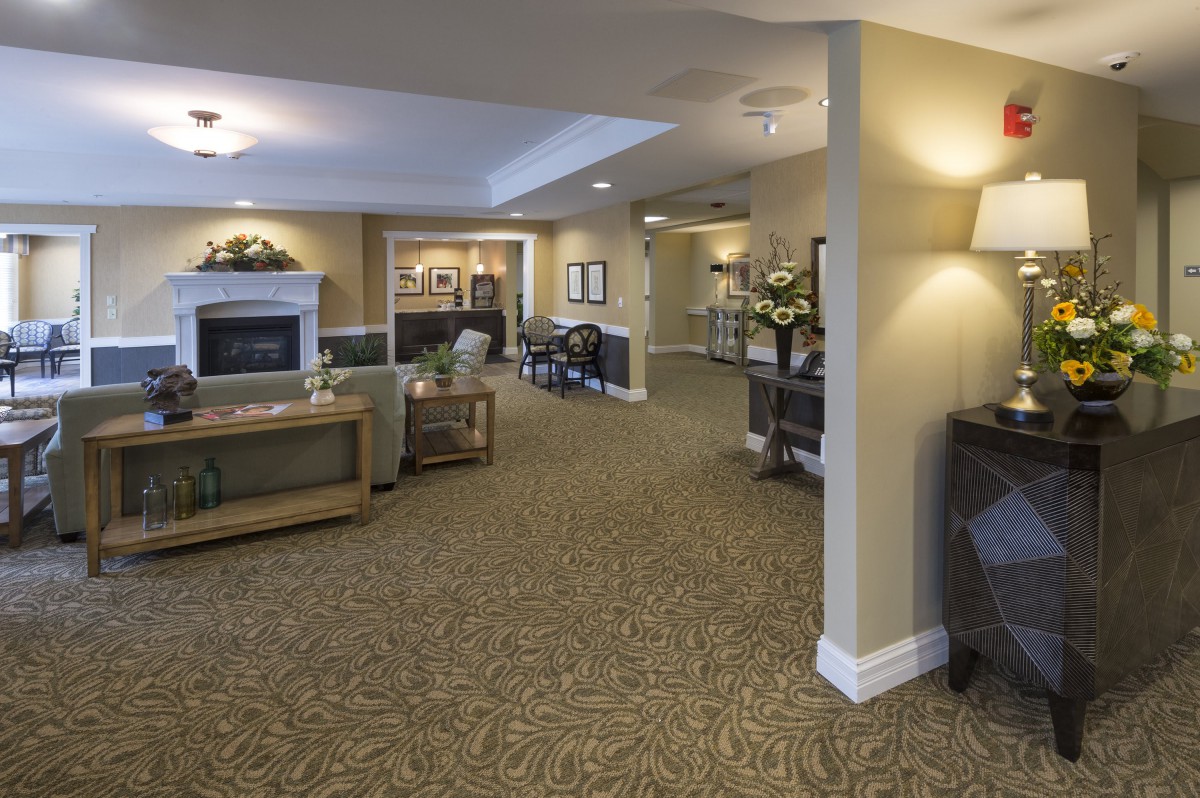 A warmly decorated living area with comfortable seating and elegant lighting.