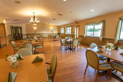 A warm and inviting dining area featuring wooden furniture and ample natural light.
