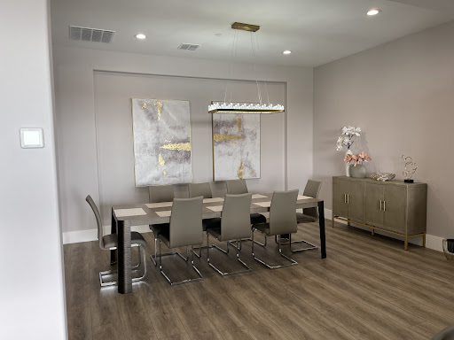 A modern meeting room featuring a stylish dining table, sleek chairs, and contemporary artwork on the walls.