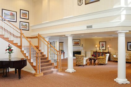 Spacious lobby area with a central staircase and elegant decor.