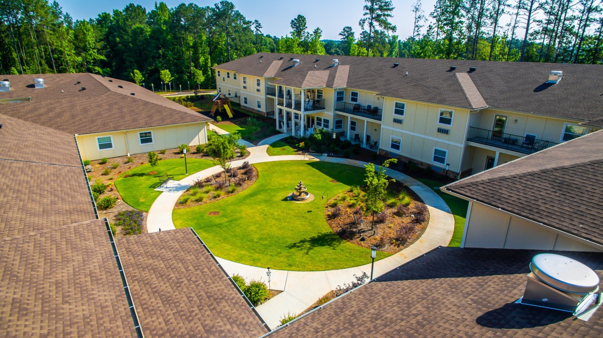 Aerial view of a residential complex with a landscaped courtyard.