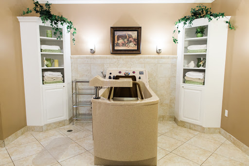 A serene spa bathroom featuring a luxurious tub and neatly arranged towels.