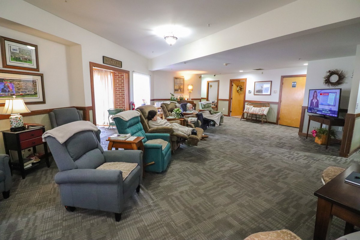 A cozy living room with comfortable seating and carpet flooring.