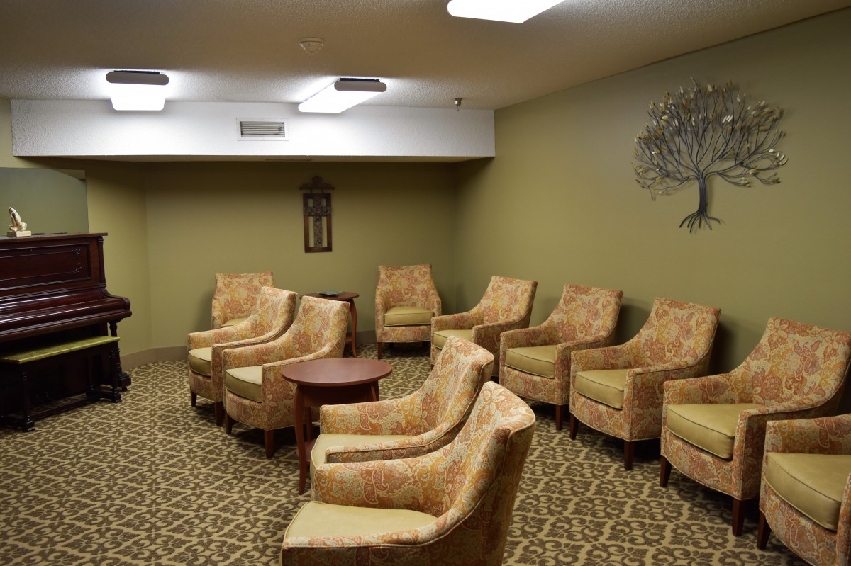 A cozy waiting room with upholstered chairs arranged in a semi-circle formation.