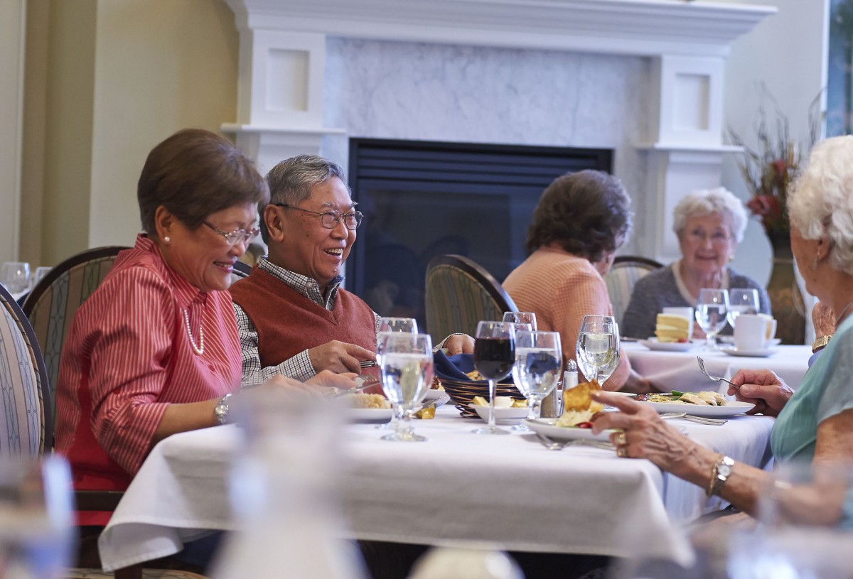 A group of seniors enjoying a meal together in a restaurant setting.