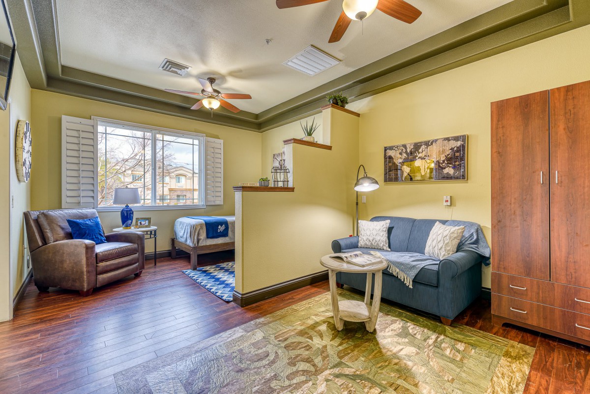 A cozy apartment interior with a living area and adjacent bedroom.