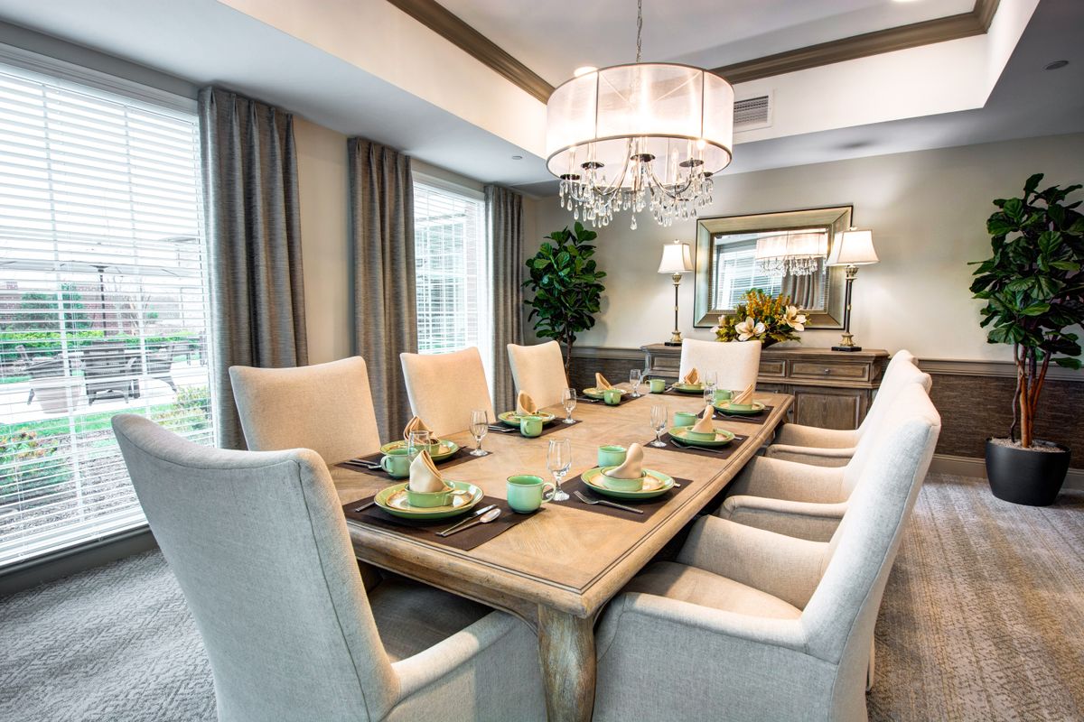 A beautifully designed dining room with elegant furnishings and a sophisticated table setting.