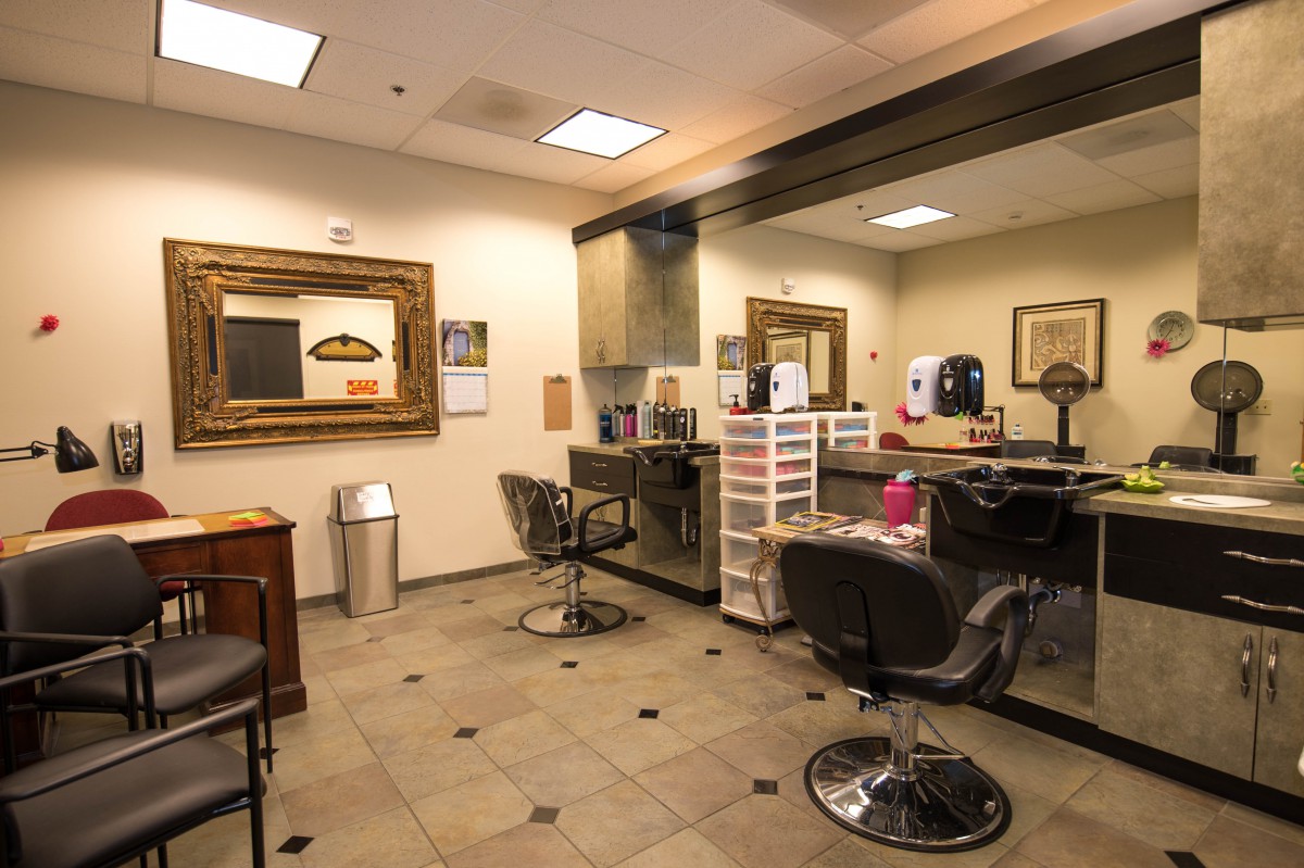 A modern beauty salon with styling chairs and mirrors.