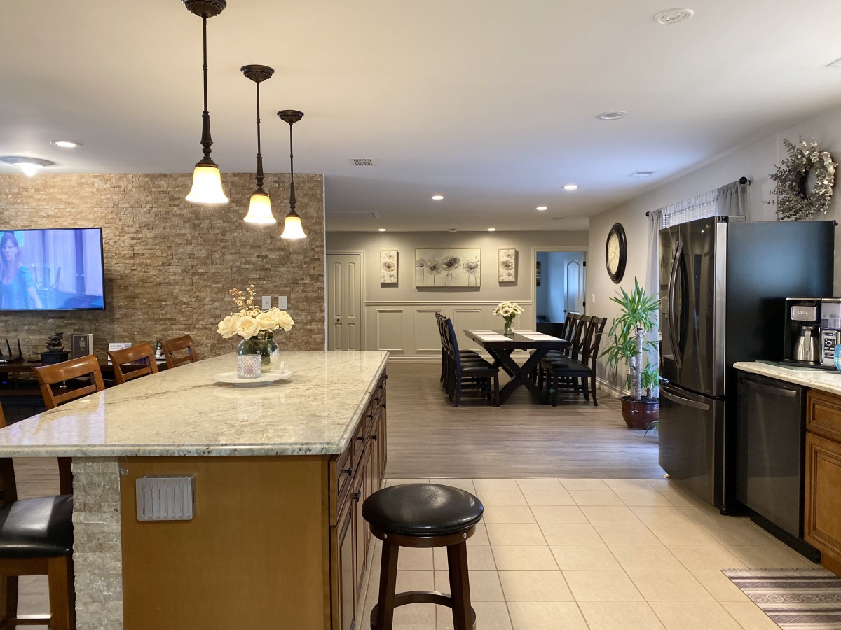 An open-concept kitchen and dining area featuring modern lighting and a spacious countertop.