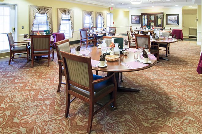 A beautifully arranged dining room with tables set for service.