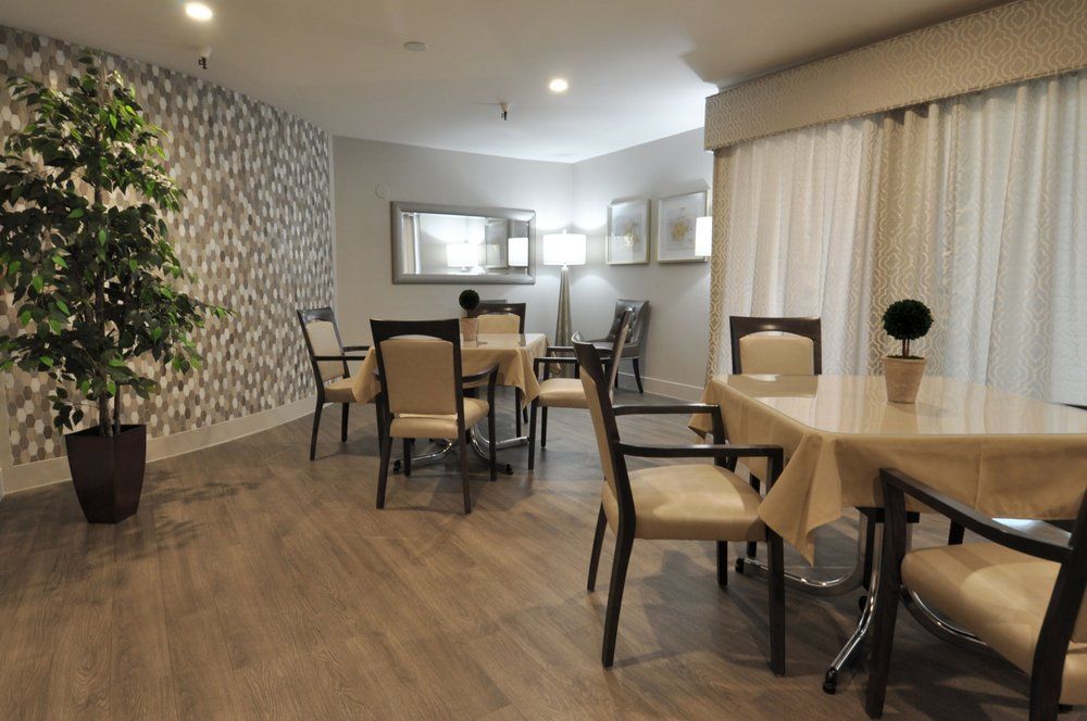 A modern dining area with neatly arranged tables and chairs, featuring stylish interior design elements.