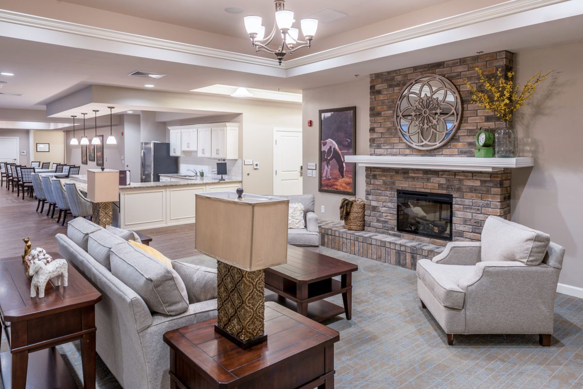 A modern living room with an open concept design, featuring a cozy fireplace and contemporary furniture.