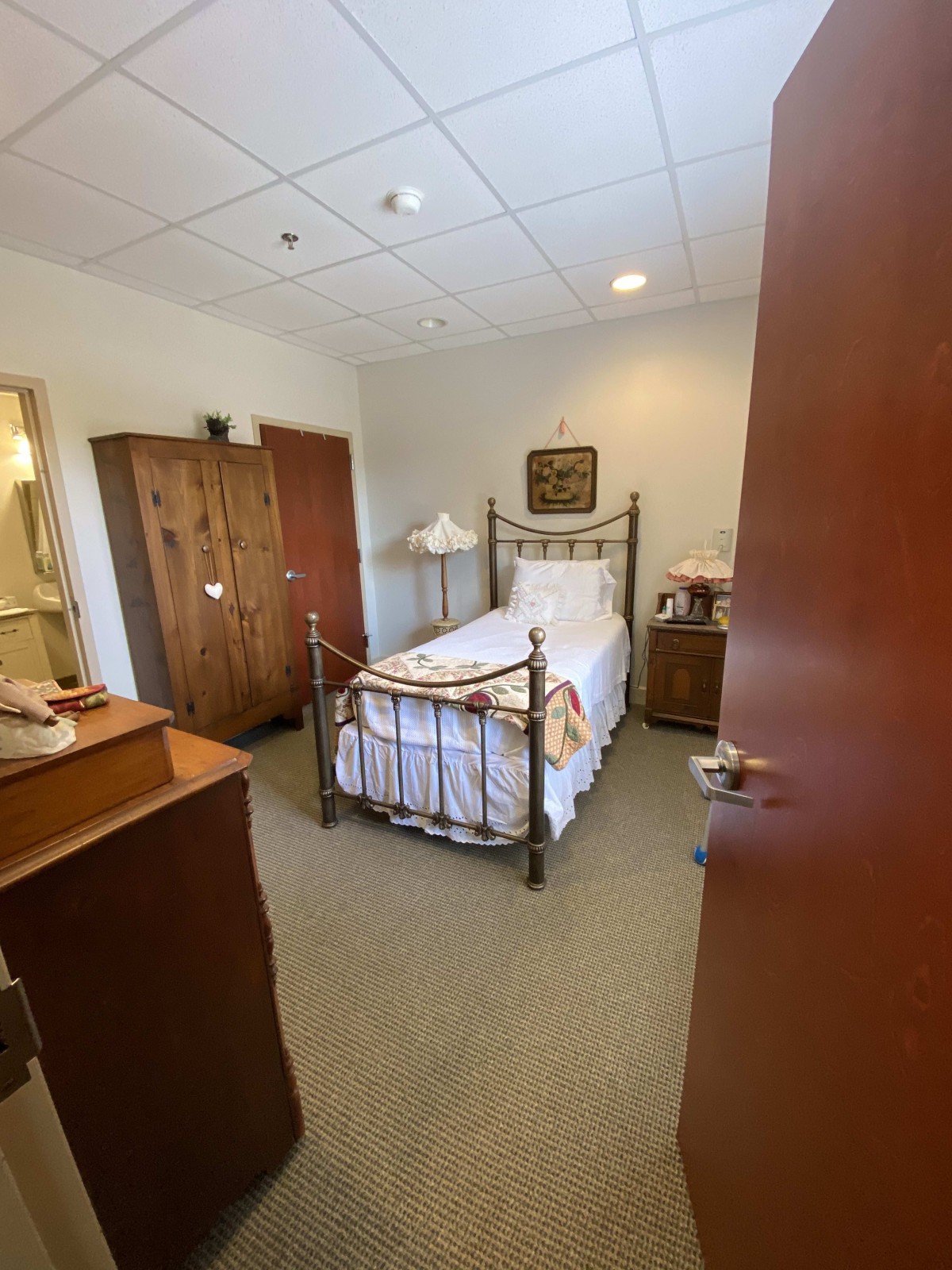 A cozy bedroom with a single bed and traditional furniture.