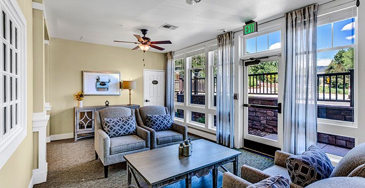 A modern living room with comfortable seating and large windows.