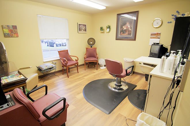 A cozy hair salon interior with a barber chair and waiting area.