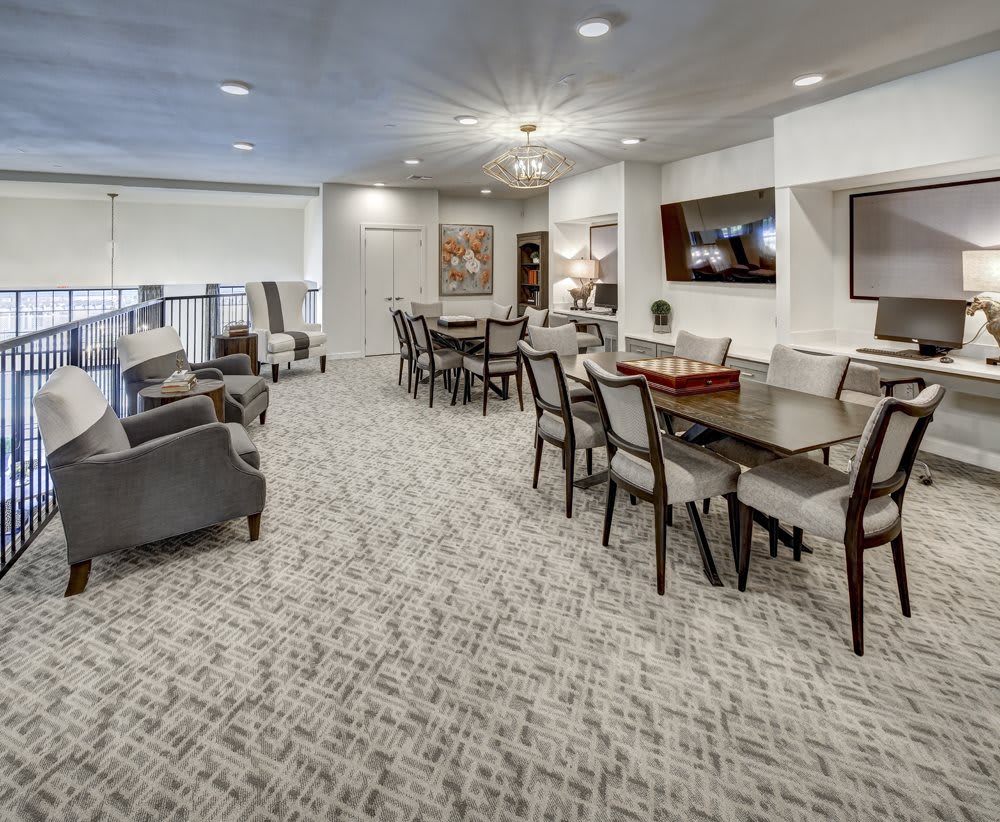 A modern and spacious lounge area with ample seating and elegant furnishings.