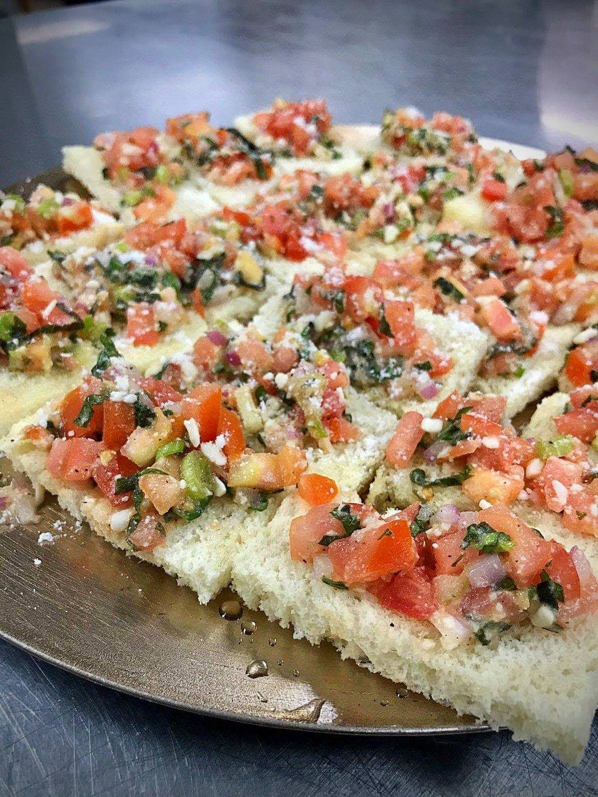 Delicious bruschetta topped with fresh tomatoes and herbs.