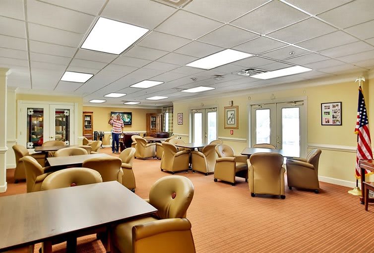 A spacious indoor lounge area with comfortable seating and bright lighting.