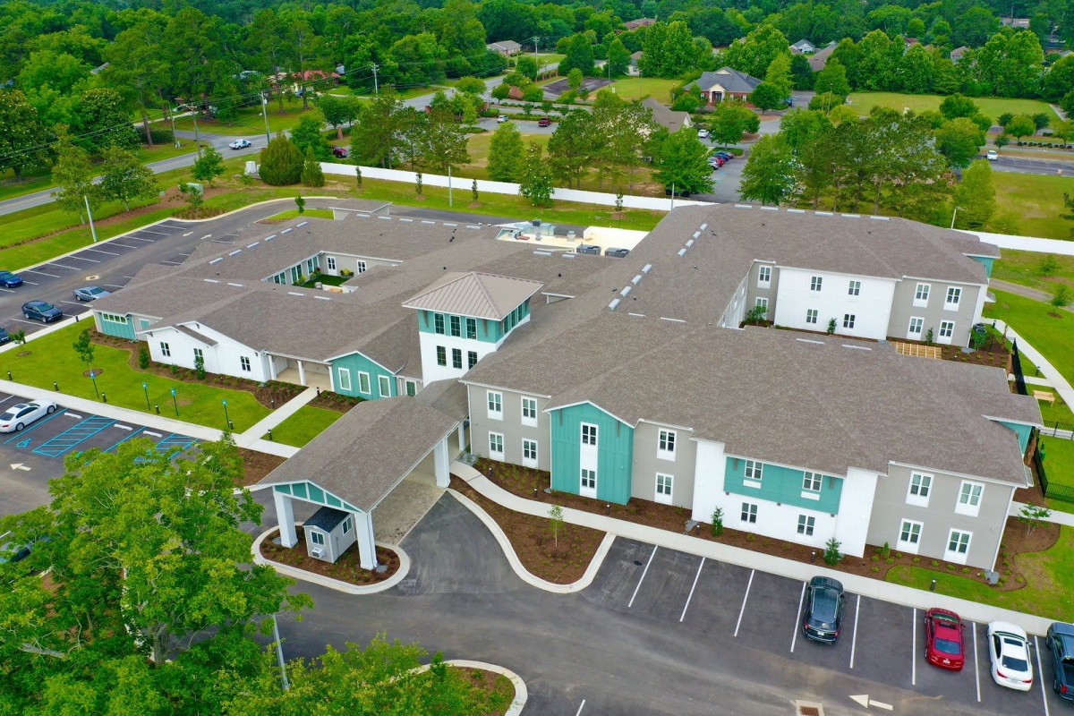 Aerial view of a residential building surrounded by greenery.