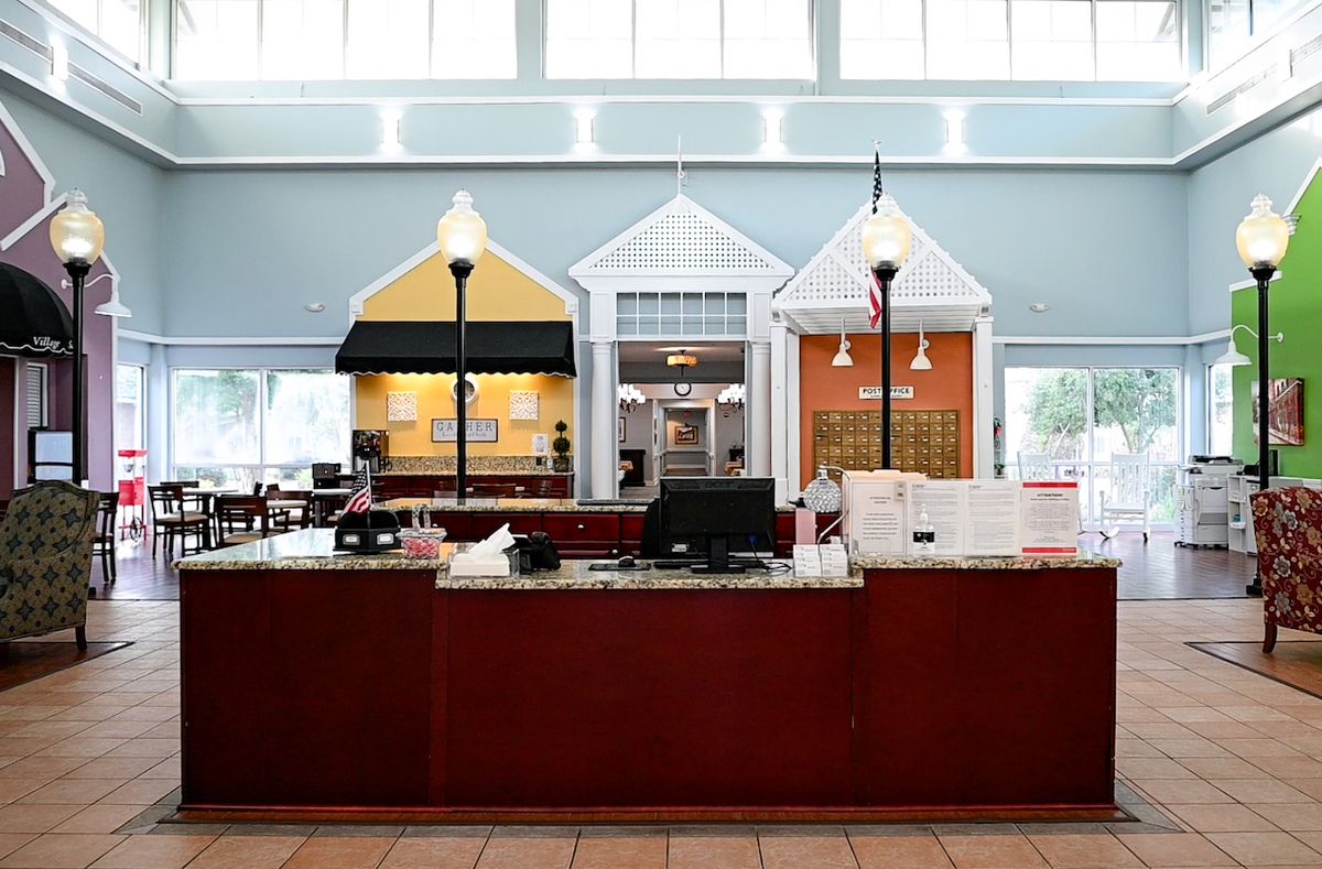 A modern reception desk area with a unique storefront design and ample lighting.