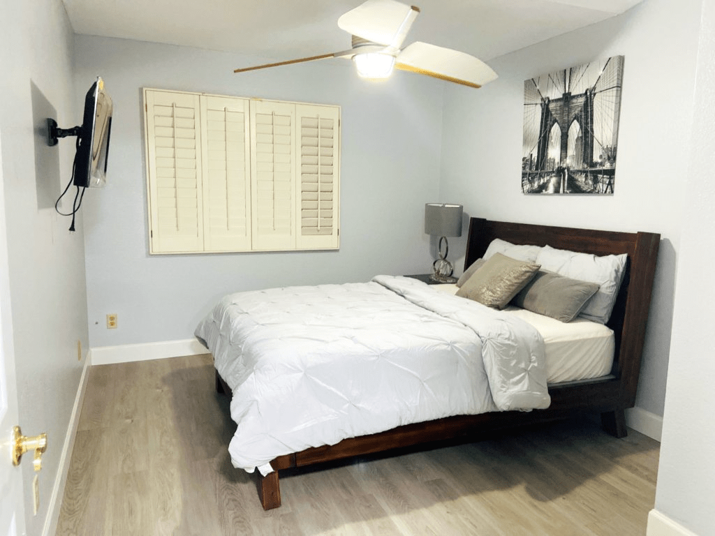A modern, minimalist bedroom with a cozy bed and stylish decor.