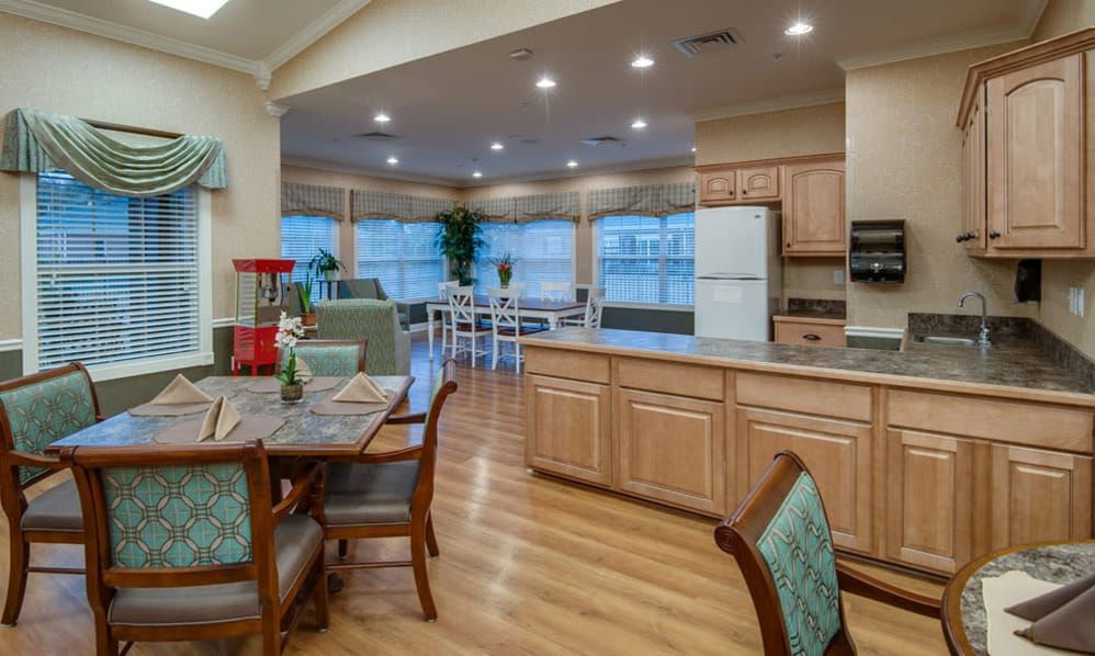A spacious open-plan kitchen and dining area with modern decor and wooden flooring.