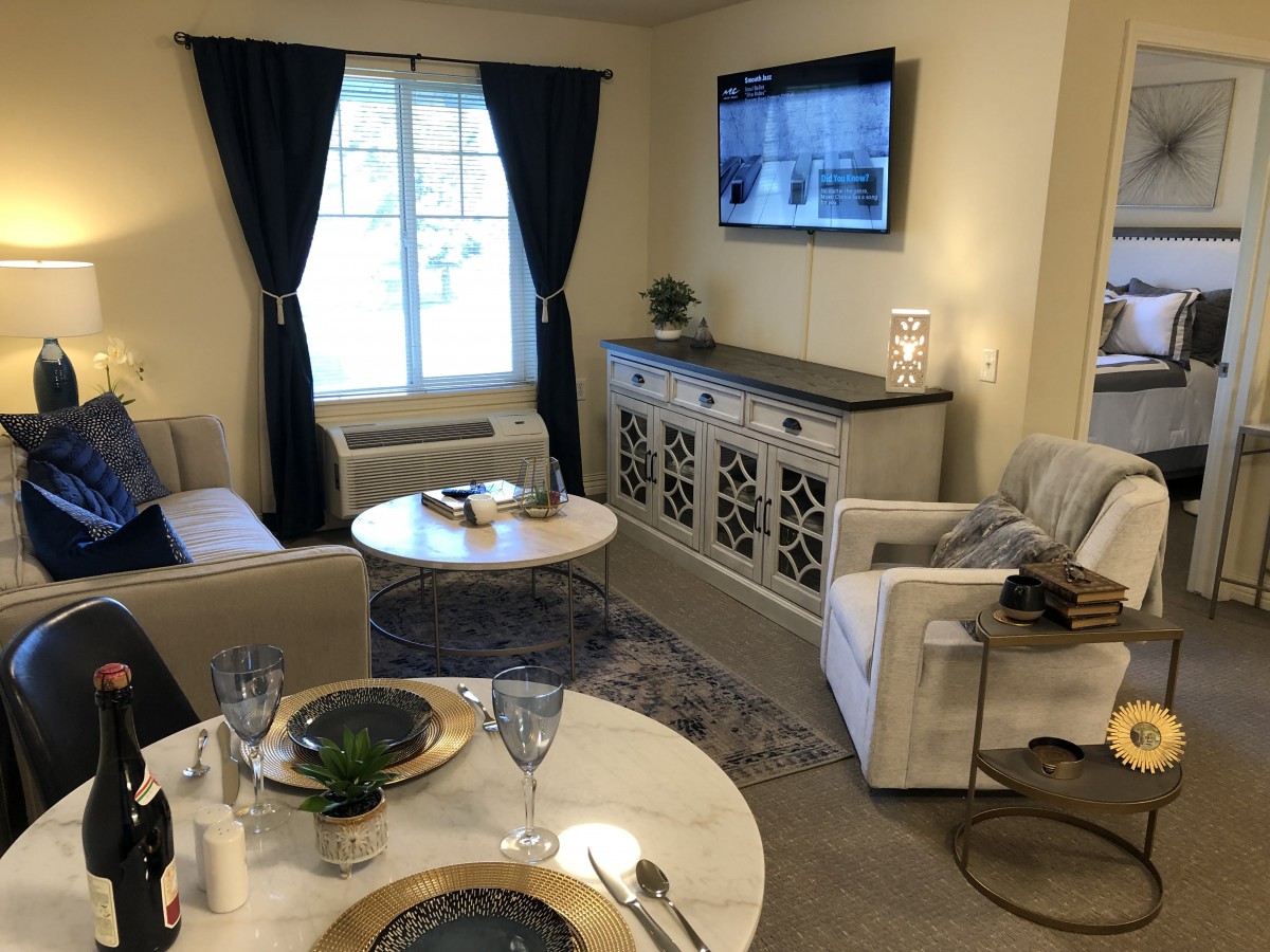 A modern living room with dining area and stylish decor.