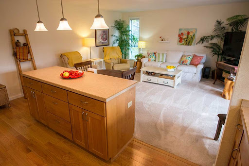 A bright and cozy living space featuring a comfortable seating area and a kitchen island, perfect for relaxation and gatherings.