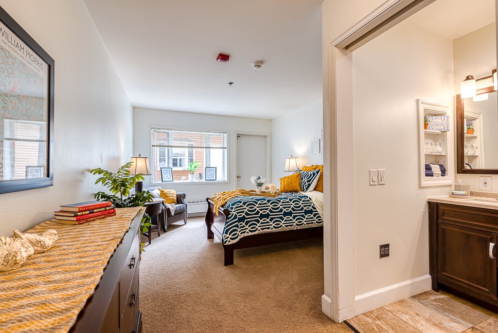 A modern and cozy bedroom with stylish decor, featuring a bed, window, and comfortable furniture.