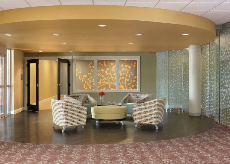 A modern waiting area with stylish seating arrangement and decorative elements.