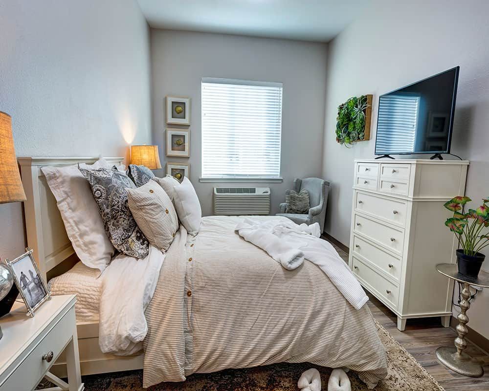 A cozy bedroom with elegant decor and a comfortable bed.