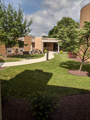 A serene garden area featuring a winding pathway and well-maintained greenery.