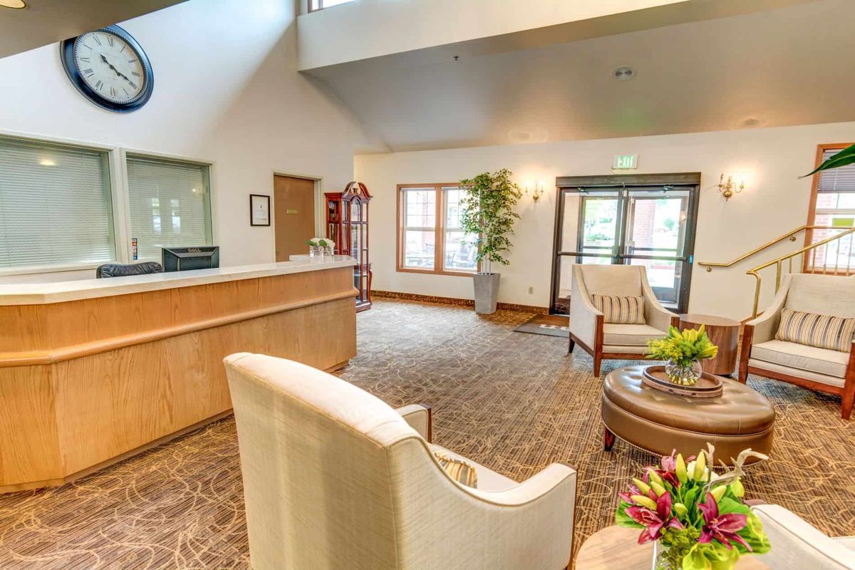 A modern lobby with a reception desk and comfortable seating.