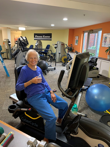 An elderly individual engaging in a workout session at the gym, showcasing dedication to fitness and health.