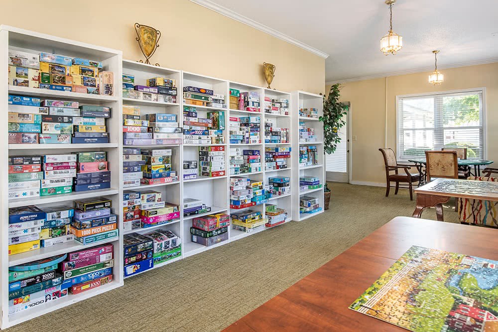 A room with shelves filled with a large collection of board games.