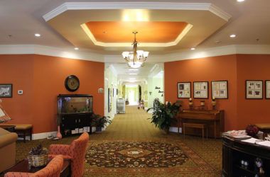 A warmly lit hallway with elegant decor and furnishings.