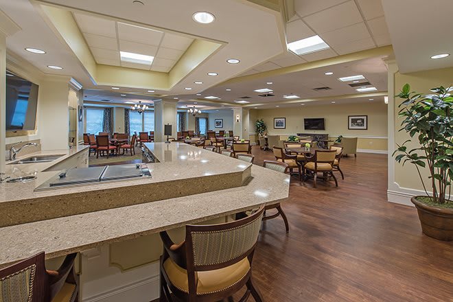 A modern dining area featuring tables, chairs, and ample lighting.