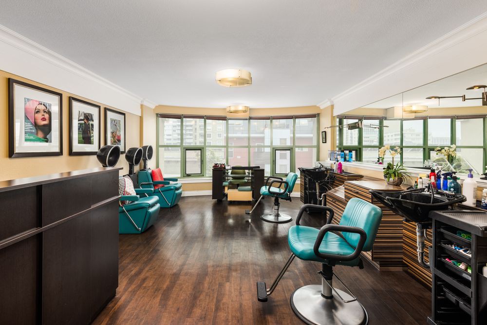 A modern hair salon interior with stylish chairs and bright natural light.