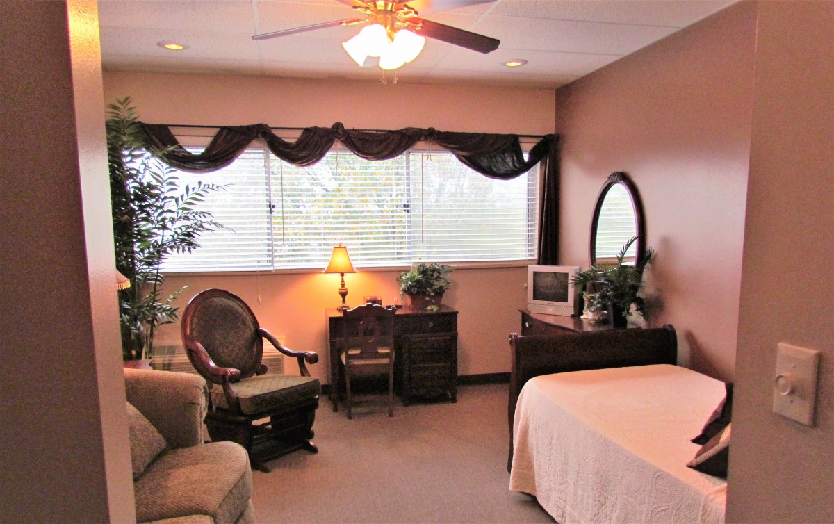 Cozy bedroom with classic furniture and warm lighting.