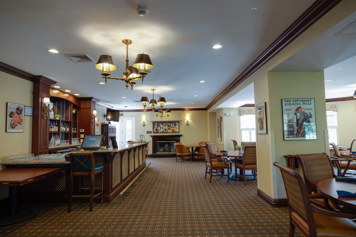 An elegant lobby with a reception desk, seating area, and a fireplace.