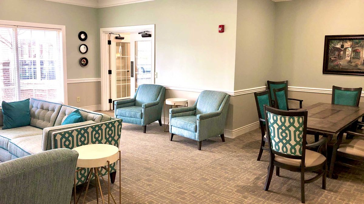 A modern seating area with comfortable chairs and tables in neutral tones.