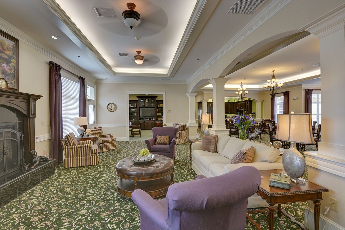 Spacious and elegantly decorated living room with comfortable seating and soft lighting.