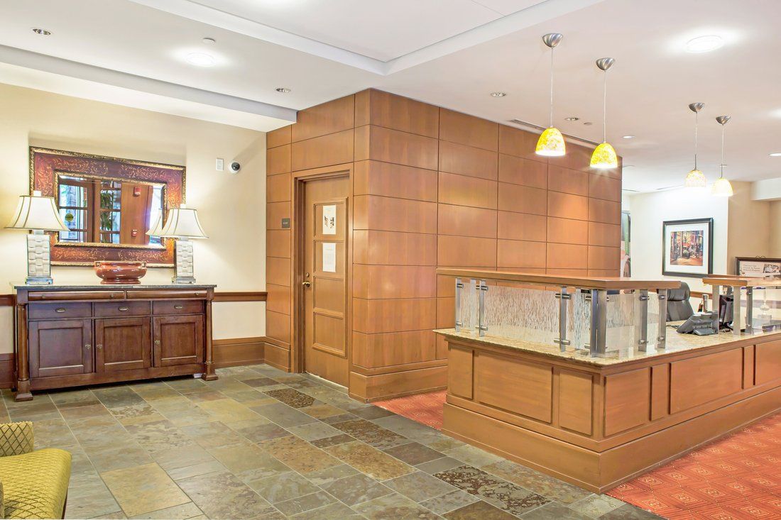 A modern lobby with wood paneling and warm lighting.