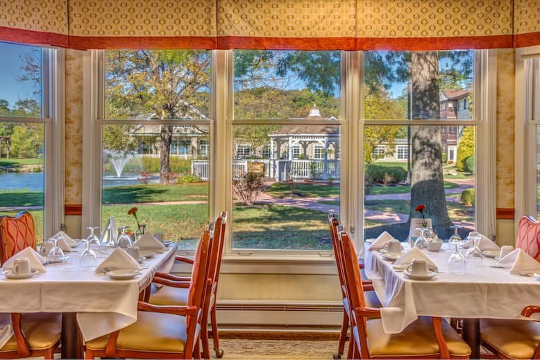 Elegant dining area with a scenic view through large windows.